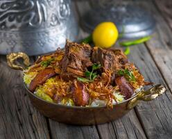 Spicy mutton biryani served in dish side view on wooden table background photo