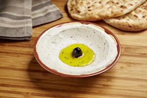 Labnah with Bread served in dish isolated on table side view of middle east food photo