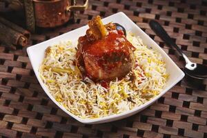 Arabian Ghoozi lamb rice biryani served in dish isolated on table side view of middle east food photo