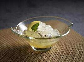 Chilled Aloe Vera in Lemonade served in a dish isolated on wooden board side view dark background photo