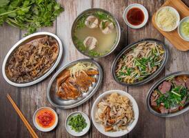 with chilli sauce, noodles, spoon and chopsticks served in dish isolated on napkin top view of hong kong food photo