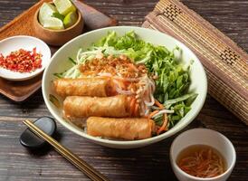 Fried Spring Rolls Cold Rice Vermicelli with sauce served in bowl isolated on table top view of taiwan food photo