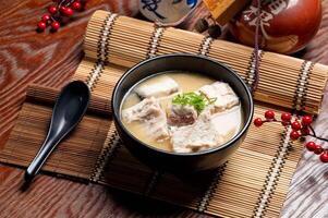 Fish Bone Miso Soup in a bowl with chopsticks isolated on mat side view of taiwan food photo