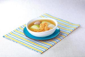 Sun Moon Fish, Huaishan Festival Melon and Pork Tendon Soup served in a bowl isolated on napkin side view of hong kong food photo