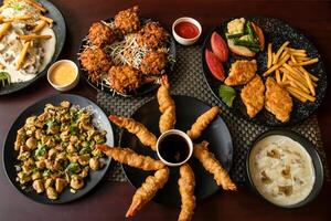 Garlic Mushroom, Vegetables Pakora, Prawn Tempura, Mushroom chicken piccata, Grilled Fish, swatted vegetables, chilli and soy sauce, mayo dip served top view of bangladesh and indian food photo