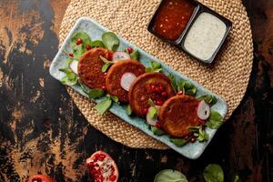 Bahraini meat Kebab with pomegranate seeds, raita and chilli sauce served in dish isolated on table top view of arabic breakfast photo