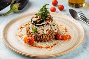 Chicken Maqluba or maqlooba kabsa biryani rice served in dish isolated on table top view of arabic breakfast photo