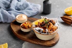 Crispy Prawns and Calimari with dip and lime served in dish isolated on table top view of arabic breakfast photo