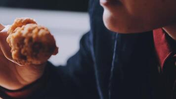 close up focus woman hand hold fried chicken for eat,girl with fast food concept video