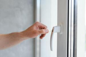 Window handle lock. Key locking window with key for kids safety. Window Restrictors in the home. photo