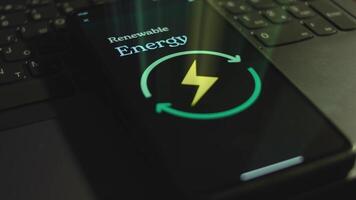 Renewable Energy inscription on smartphone screen. Graphic presentation with Energy symbol on black background. Light rays. Power and Energy concept video