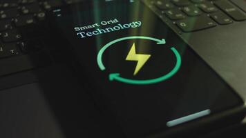 Smart Grid Technology inscription on smartphone screen. Graphic presentation with Energy symbol on black background. Light rays. Power and Energy concept video