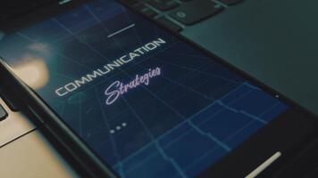 Communication strategies inscription on mobile phone screen. Communication concept. Analog effect video