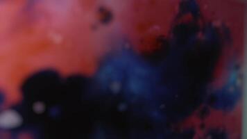 Cosmic abstract red and blue background imitating colored dust, splashes of paint. Image duplication effect video