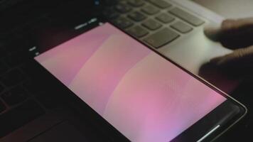 Abstract background of pink waves on smartphone screen. Rays of light come from screen. Male hand flapping with fingers cheerfully video