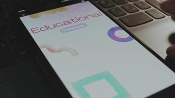 Educational technology inscription on smartphone screen. Graphic presentation with watercolor brushstrokes on background. Education concept video