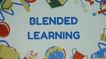 Blended learning inscription on background with drawn school supplies. Online instruction using modern technology with physical place based classroom methods. Education concept. Blurred video