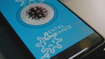 Dental Insurance inscription on smartphone screen. Graphic presentation of a rotating virus cell. Healthcare and Medical Insurance concept video