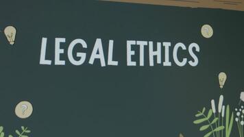 Legal Ethics inscription on chalkboard background. Graphic presentation of drawn teacher and student standing at chalkboard. Legal concept video