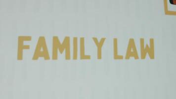 Family Law inscription on white background. Graphic presentation with drawn portraits of Afro-American people of various professions . Legal concept video