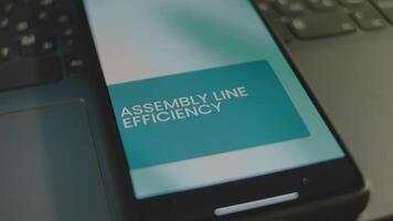 Assembly Line Efficiency inscription on smartphone screen. Graphic presentation with moving colored ovals on background. Manufacturing concept video