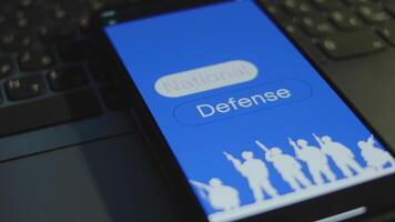 National Defense inscription on smartphone screen with blue background. Graphic presentation with silhouettes of soldiers with military equipment. Military concept video