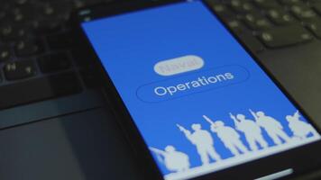 Naval Operations inscription on smartphone screen with blue background. Graphic presentation with silhouettes of soldiers with guns. Military concept video