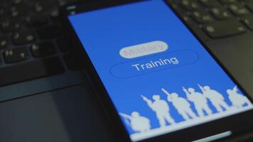 Military Training inscription on smartphone screen with blue background. Graphic presentation with silhouette of a group of soldiers with guns. Military concept video