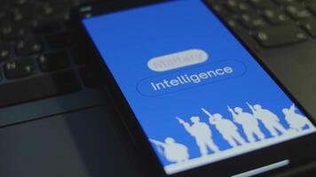 Military Intelligence inscription on smartphone screen with blue background. Graphic presentation with silhouettes of soldiers with guns. Military concept video