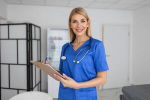 Portrait of female health care professional, doctor, with stethoscope. Portrait of beautiful mature woman doctor holding digital tablet and looking at camera. photo