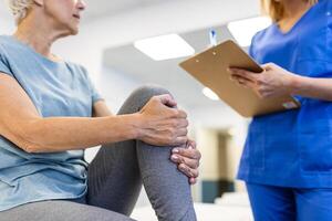 Senior female patients consulted physiotherapists with knee pain problems for examination and treatment. Rehabilitation physiotherapy concept. photo