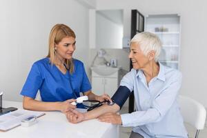 Doctor using sphygmomanometer with stethoscope checking blood pressure to a patient in the hospital. Hypertension and high heart rate photo