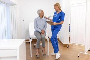 Portrait of female doctor explaining diagnosis to her patient. Female Doctor Meeting With Patient In Exam Room. Shot of a medical practitioner reassuring a patient photo