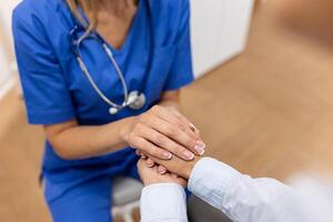 Emotional comfort stored in fingerprints. Shot of an unrecognizable doctor holding hands with her patient during a consultation. photo