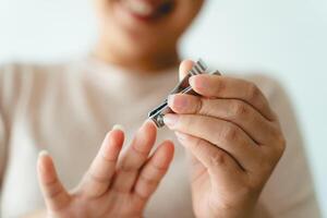 A woman is holding a pair of nail clippers photo