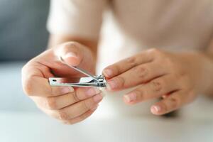 A woman is holding a pair of nail clippers photo