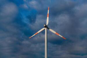 Wind turbine on the background of the blue sky. Clean renewable energy. Electric power production. photo