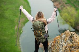 joven mujer con mochila excursionismo en el montañas. excursionismo concepto. trekking acantilados viajar, viajero. foto