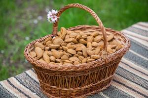 almendra nueces en un cesta en un de madera antecedentes. foto