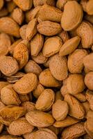Almond nuts in a basket on a wooden background. photo