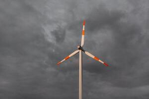 Wind turbine on the background of the blue sky. Clean renewable energy. Electric power production. photo