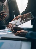 Business team meeting present, investor colleagues consultation and conference new strategy plan business and market growth on financial document graph report, Meeting and Talking. photo