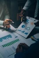 Business team meeting present, investor colleagues consultation and conference new strategy plan business and market growth on financial document graph report, Meeting and Talking. photo