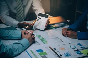 Business team meeting present, investor colleagues consultation and conference new strategy plan business and market growth on financial document graph report, Meeting and Talking. photo