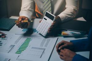Business team meeting present, investor colleagues consultation and conference new strategy plan business and market growth on financial document graph report, Meeting and Talking. photo