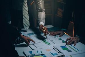 Business team meeting present, investor colleagues consultation and conference new strategy plan business and market growth on financial document graph report, Meeting and Talking. photo