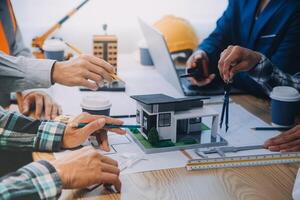 Image of engineer meeting for architectural project. working with partner and engineering tools on workplace vintage tone. photo