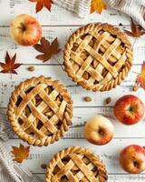 AI generated Top view of an Apple Pies on white wooden background photo