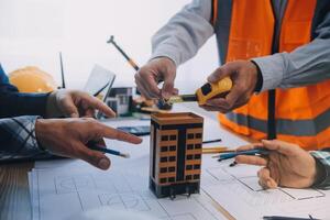 Image of engineer meeting for architectural project. working with partner and engineering tools on workplace vintage tone. photo