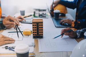 Image of engineer meeting for architectural project. working with partner and engineering tools on workplace vintage tone. photo